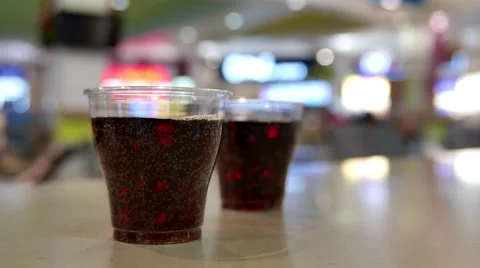 A cup of coca cola on table inside shopping mall Stock Footage 57509313