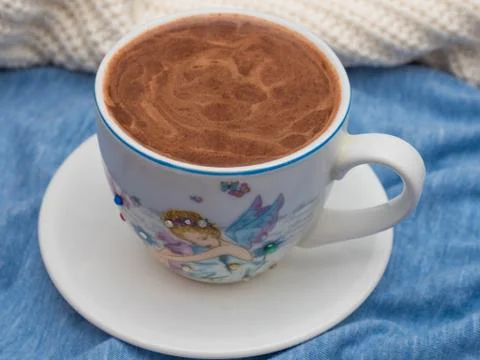 Cup of cocoa with foam on the table Stock Photos
