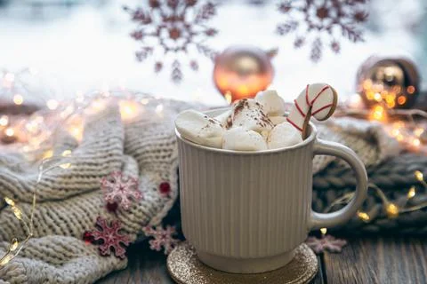 A cup of cocoa with marshmallows close-up on a blurred background. Stock Photos