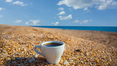 Cup of cofee on a sandy sea beach Stock-Footage 335784870