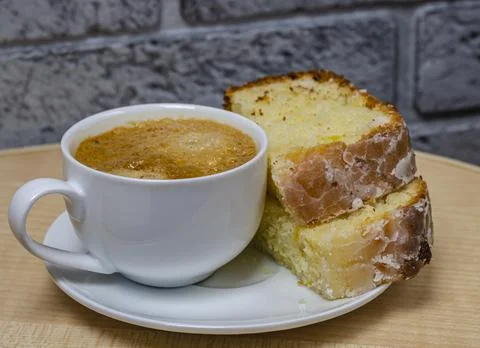 Cup of coffe and two pieces of cupcake on a white plate close-up Foto stock