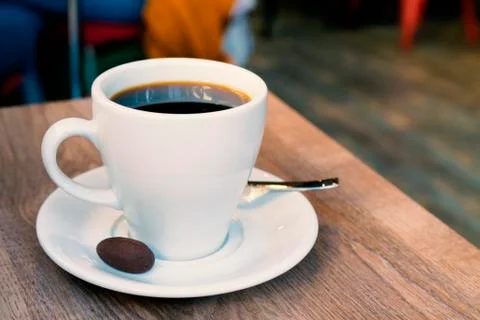 Cup of coffe with small cookie at cafeteria Stock Photos