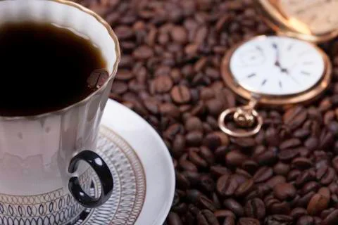 Cup of coffee against beans background closeup Foto stock