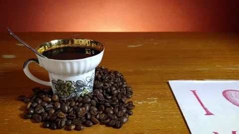 Cup with coffee among coffee beans and a leaf with the inscription I love you Stock-Footage 147656762