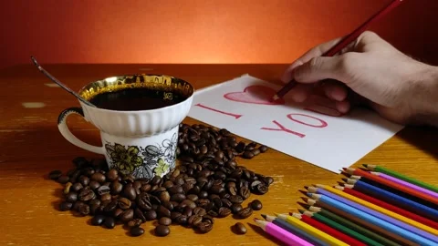 Cup with coffee among coffee beans and a leaf with the inscription I love you Stock-Footage 147668525
