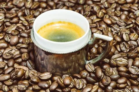 Cup of coffee and beans at backrounds Stock Photos