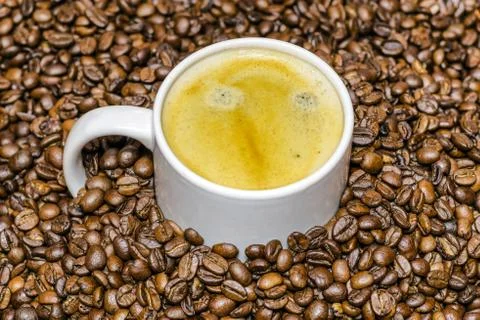 Cup of coffee and beans at backrounds Stock Photos