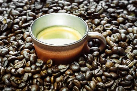 Cup of coffee and beans at backrounds Stock Photos