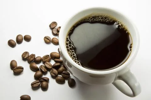 The cup of coffee and beans Stock Photos