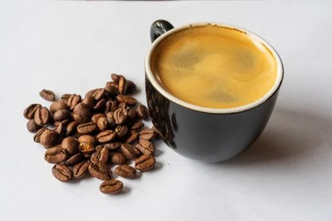 Cup of coffee and beans Stock Photos