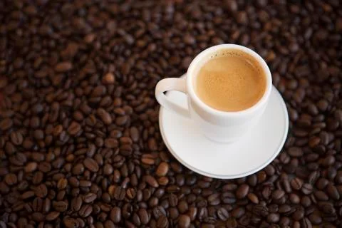 Cup of coffee and beans on table Stock Photos