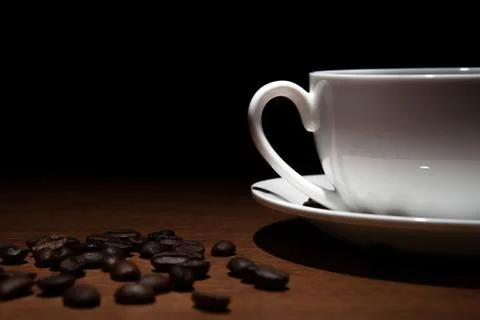 Cup of coffee and beans on the table Stock Photos