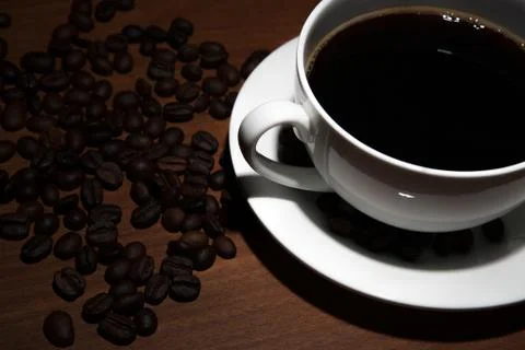 Cup of coffee and beans on the table Stock Photos