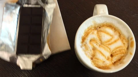 A cup of coffee and a chocolate bar. Stock Footage 86414944