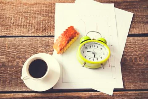 Cup of coffee and clock on document paper Stock Photos