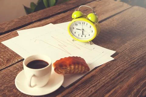 Cup of coffee and clock on document paper Stock Photos