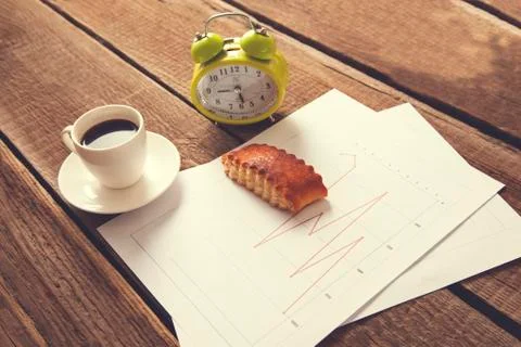 Cup of coffee and clock on document paper Stock Photos