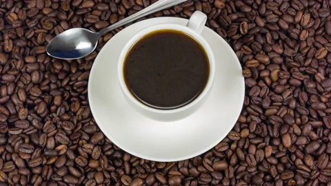 Cup of coffee and coffee beans and spoon close up rotation Video stock 89596389