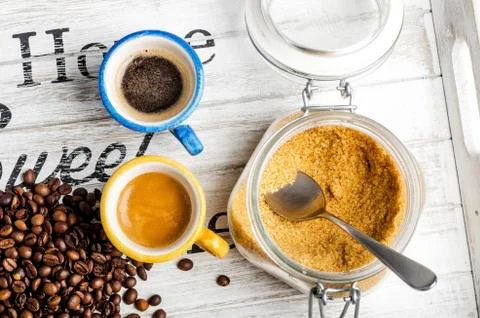 Cup of coffee and coffee beans and cane sugar Stock Photos