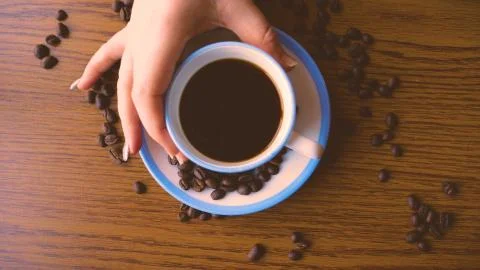 A cup of coffee and coffee beans, blueberries and strawberries Stock Photos