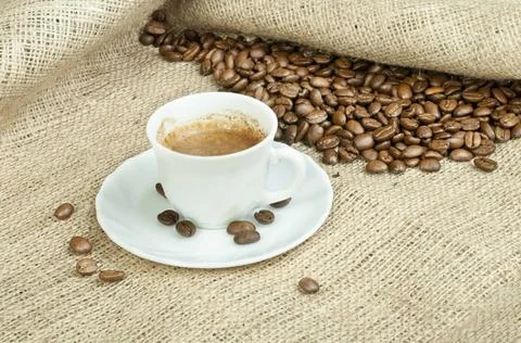 Cup of coffee and coffee beans Cup of coffee and coffee beans on burlap ,m... Stock-Fotos