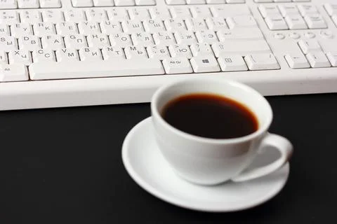 A cup of coffee and a computer keyboard 스톡 사진
