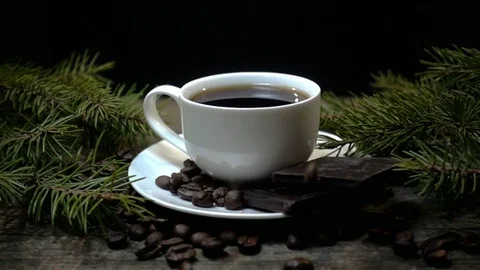 A cup of coffee and falling coffee beans in slow motion Stock Footage 83334739