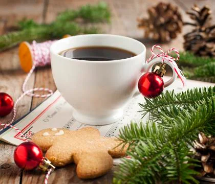 Cup of coffee and gingerbread cookie with christmas decorations Stock Photos