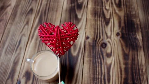 Cup of coffee and handmade heart in hand Stock Footage 73360091