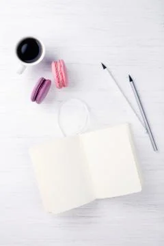 A cup of coffee and macarons on the table. Stock Photos
