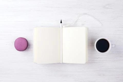 A cup of coffee and macarons on the table. Stock Photos