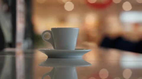 A cup of coffee and multicolored defocused bokeh lights background Vídeos de archivo 335645075