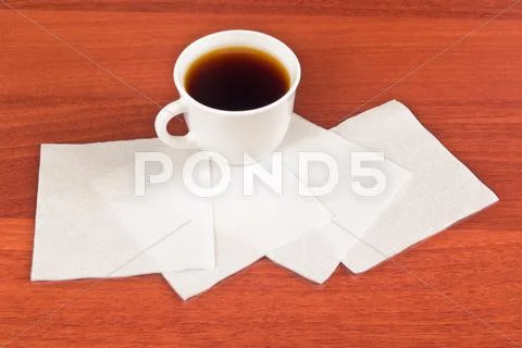 Cup of coffee and napkin Stock Photos