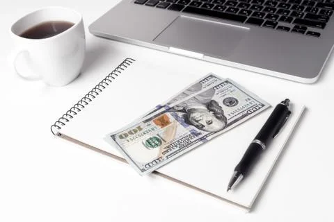 Cup With Coffee And Notebook On Which Lie Two Hundred Dollars Ne Stock Photos