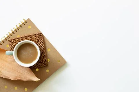 Cup of coffee and notebook on white background. Work and study place Stock Photos