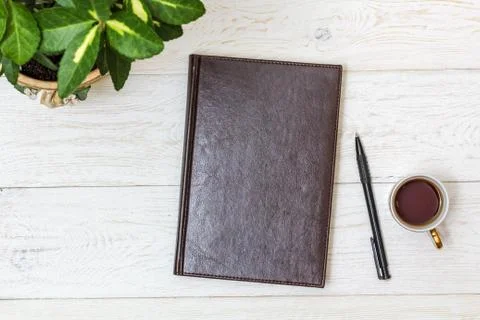 Cup coffee and notepad on white boards Stock Photos