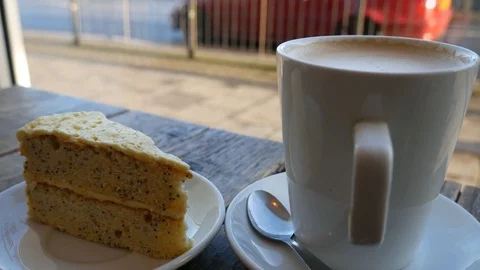 A cup of coffee and a piece of cake on the table in a cafe. Stock Footage 84191233