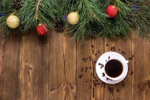 Cup of coffee and pine nuts on a brown wooden background. A branch of a fluffy Foto stock