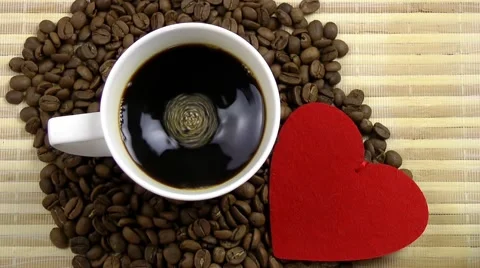 Cup of Coffee and  Red Heart on Coffee Beans Stock Footage 68036367