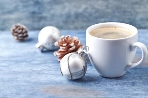 A cup of coffee and a small Christmas bauble Stock Photos