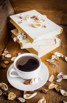 Cup of coffee and stack of old books. Wooden background Stock Photos