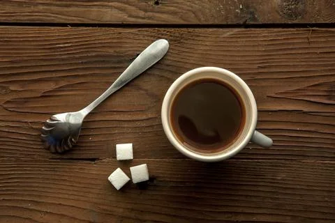 Cup of coffee and sugar cubes. Stock Photos