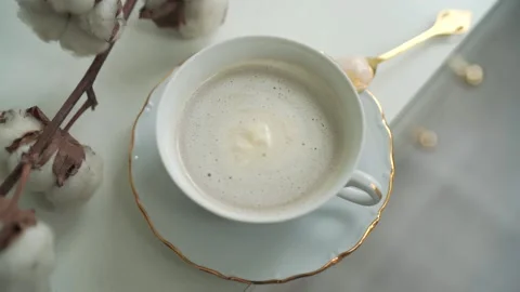 A cup of coffee and a tea spoon on a plate Stock Footage 150865315
