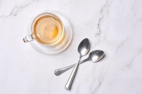 A cup of coffee and two spoons on a Stock Photos