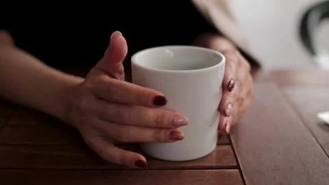 A cup of coffee and woman's hands at cafe. No face. Stock Footage 224449689