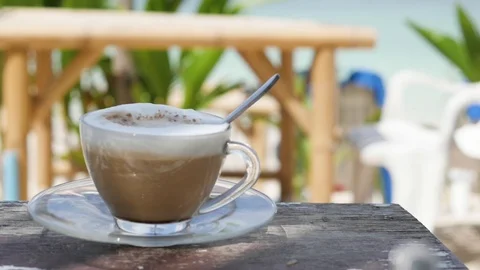 Cup of coffee on the background of the beach, sea and greenery. breakfast on the Stock-Footage 126308579