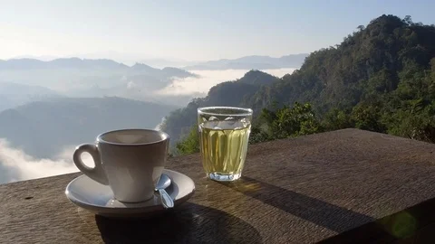 Cup of coffee on a background of blue sky and clouds Stock Footage 102597200