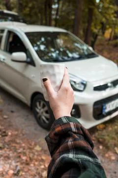 Cup of coffee on the background of the car. Stock Photos
