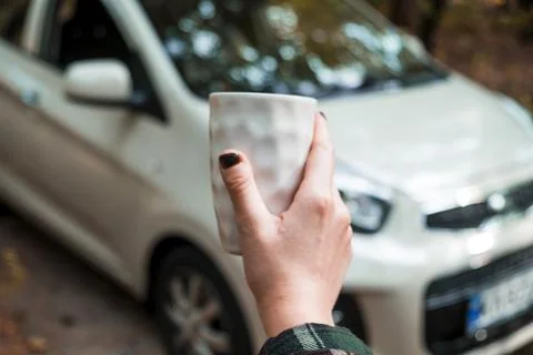 Cup of coffee on the background of the car. Stock Photos