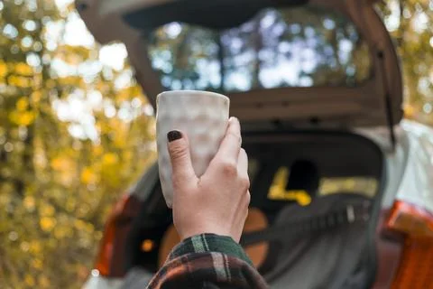 Cup of coffee on the background of the car. Stock Photos